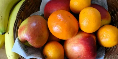 A bowl of apples, oranges, and bananas.