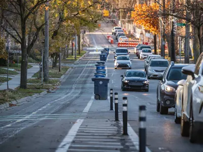 Photo of two-way bike lane with large buffer; carts go in buffer. 