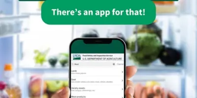 A person holds a phone screen in front of a fridge. On the screen is the USDA FoodKeeper App home screen. Text in green boxes at the top of the page reads "Wondering if last week's groceries are still safe to eat? There's an app for that!"